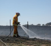 A firefighter mops up at Gumeracha