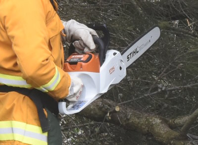 A battery powered chainsaw at work